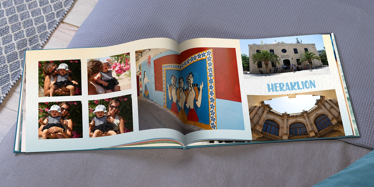 An open CEWE PHOTOBOOK shows four small pictures of Magy and Hannah, three photos of buildings and the headline "HERAKLION".