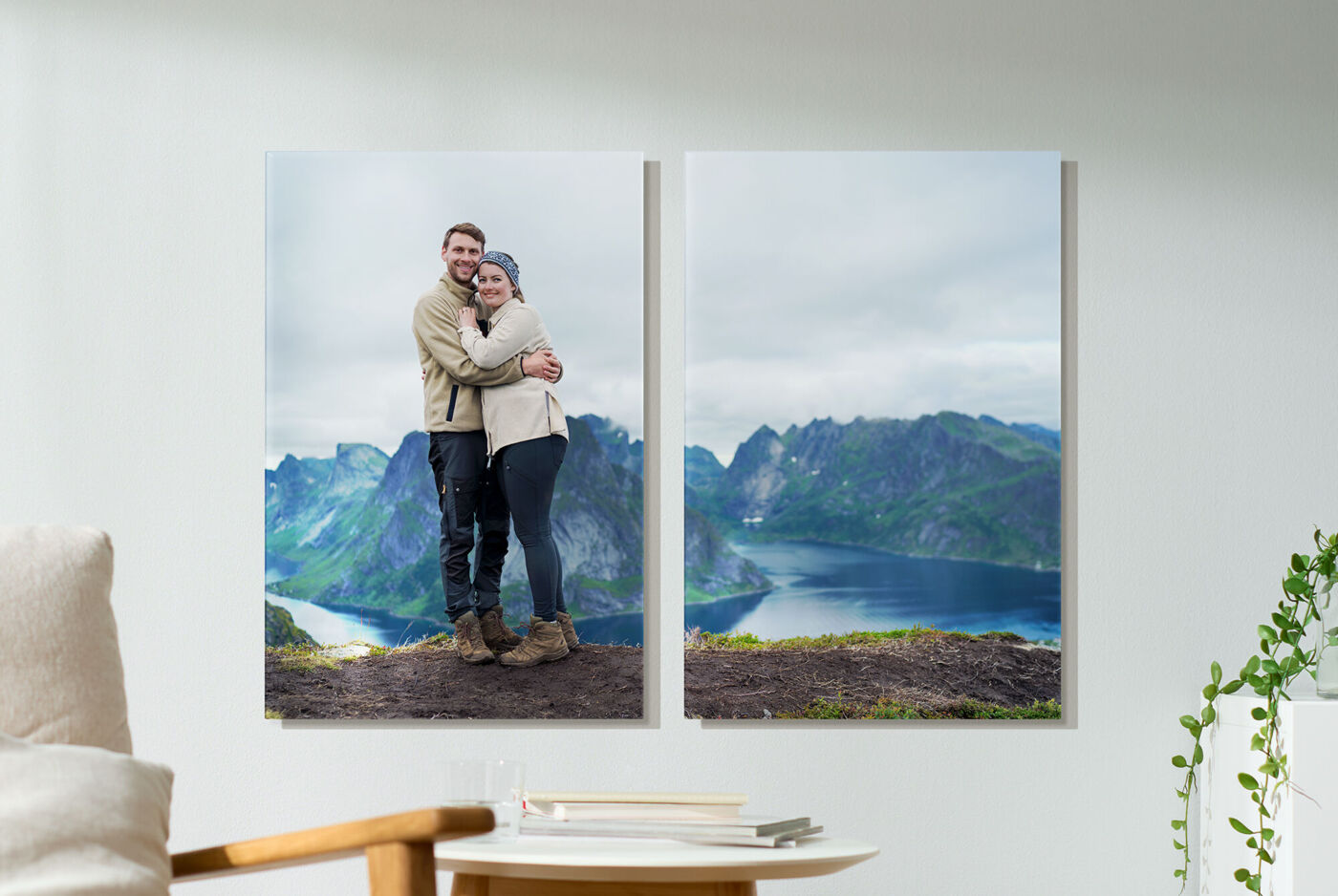 A couple stands happily embraced at a viewpoint before an impressive mountain landscape. The view of the fjord is breathtaking.