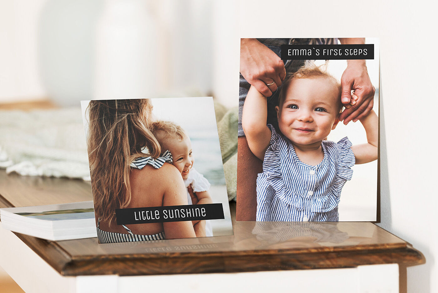 Two lovingly designed greeting cards on a table, one with a toy and the other with a girl taking her first steps