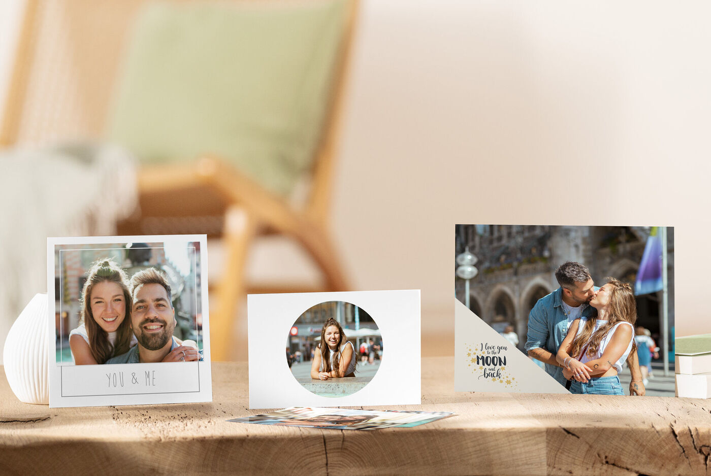 Three individually designed CEWE greeting cards on a wooden table expressing memories and connection
